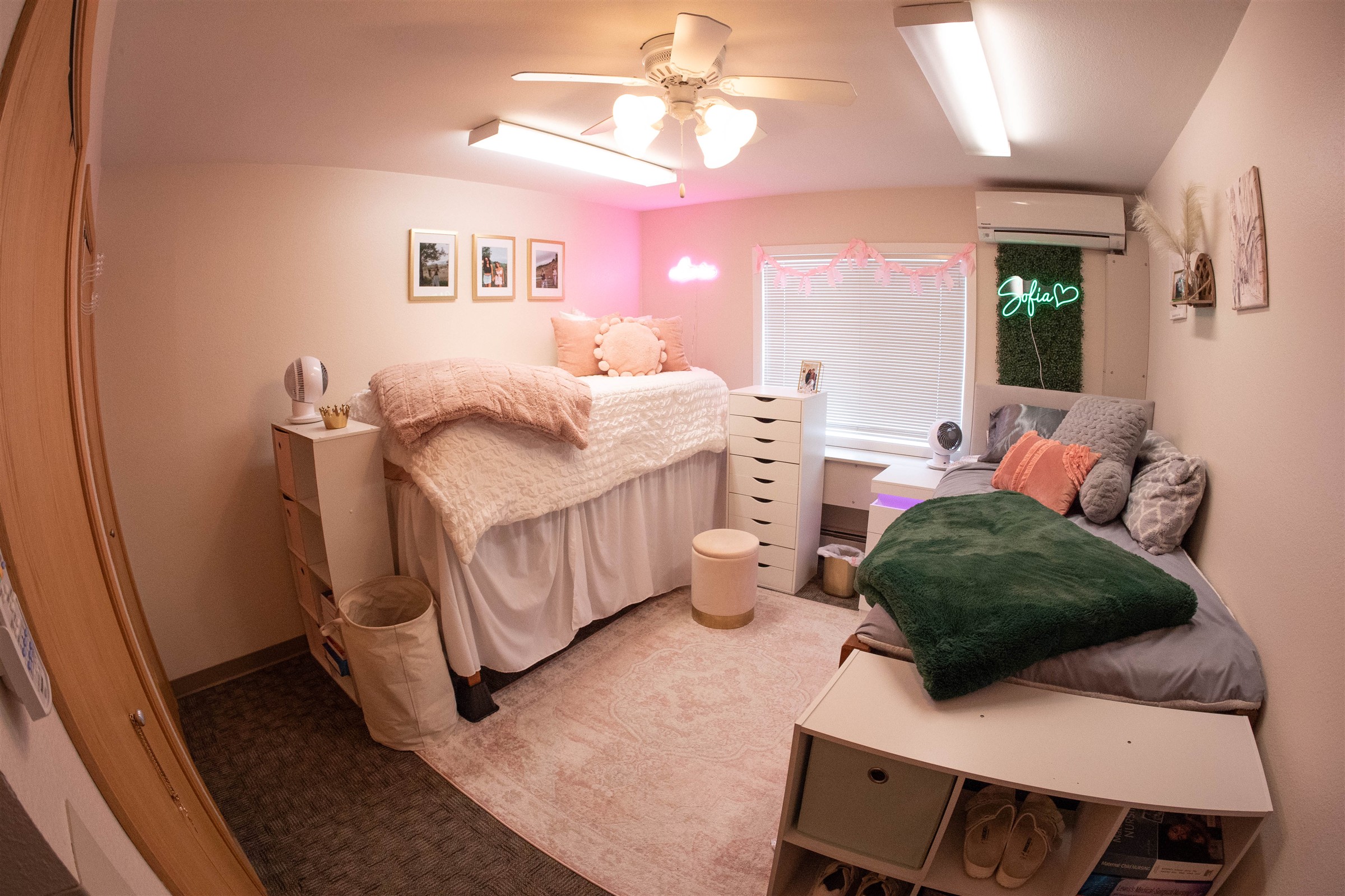 Interior of Mystic hall dorm room with pink and green decorations